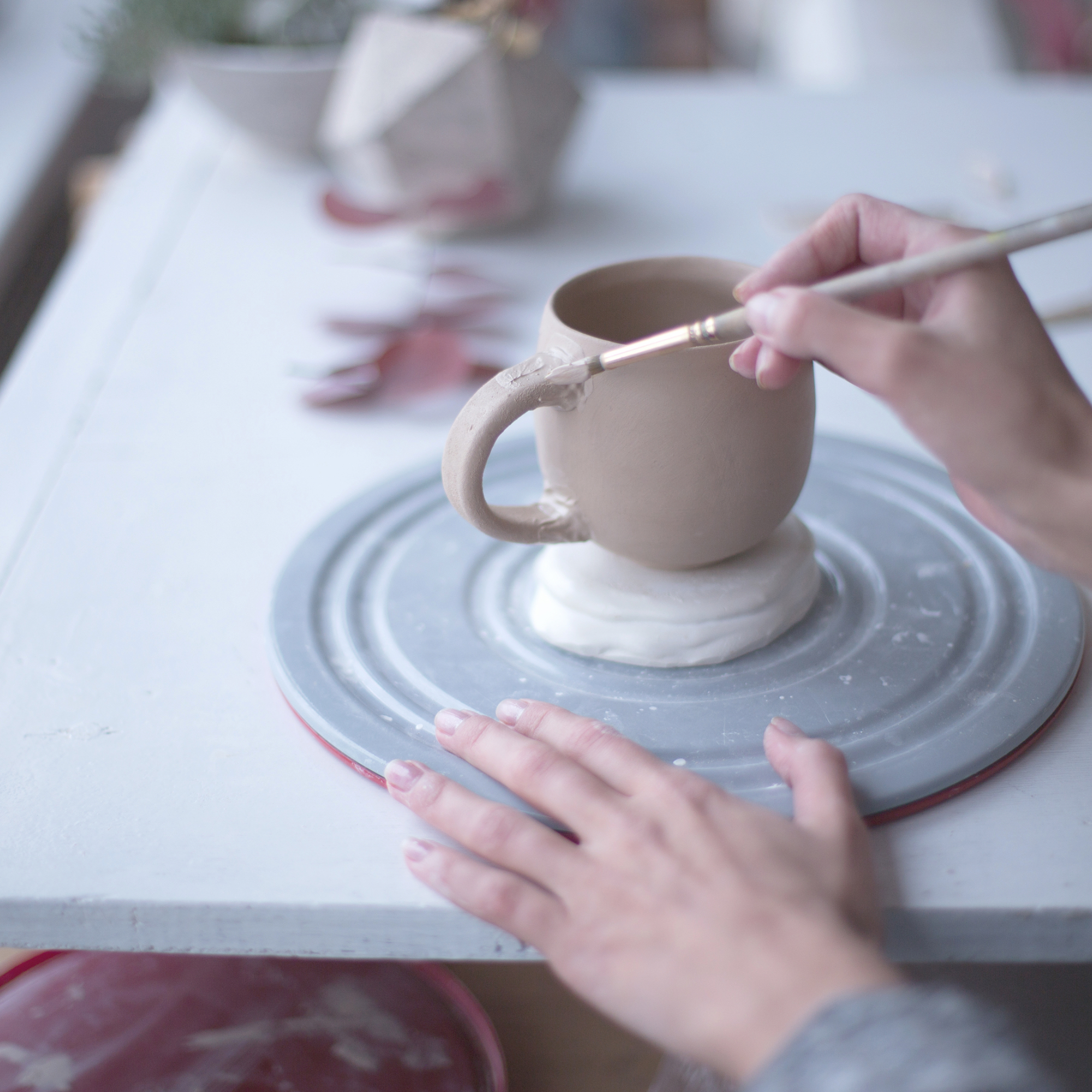 Hands holding a handmade mug