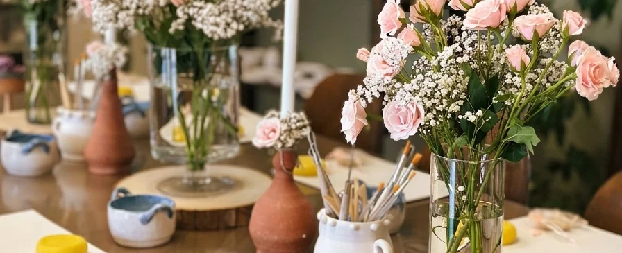 Party table set with pottery and flowers