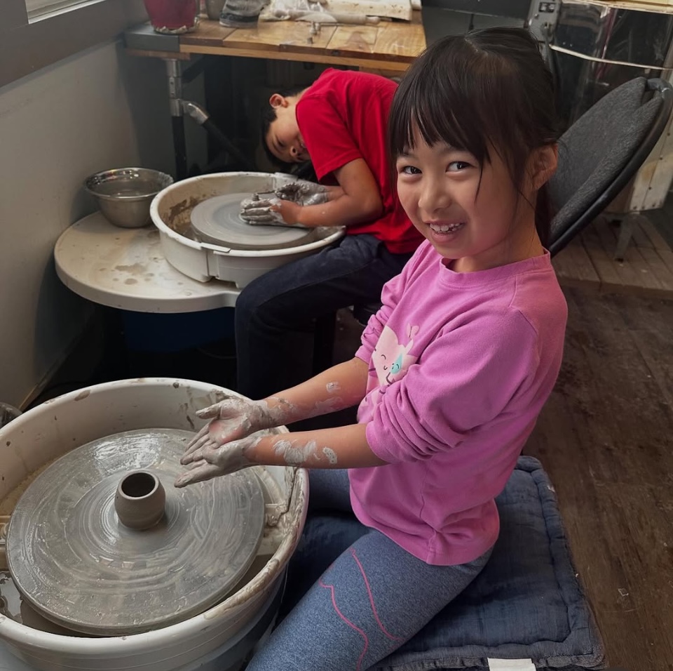 A child at the potter's wheel